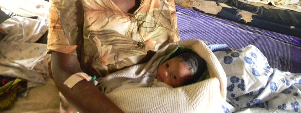 A newborn baby and mother in rural Uganda